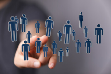 Concept of digital networking with human icons.  Touching hand with digital human figures in a virtual cloud. T