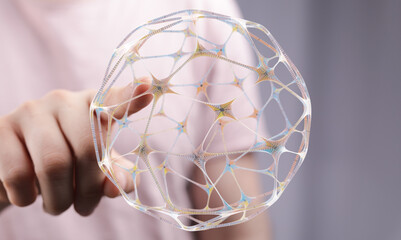 Abstract image showing a hand interacting with a digital sphere representing interconnected data, networks, and communication technol