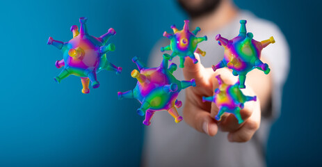 Abstract conceptual image of a hand touching colorful 3D rendered virus particles illustrating health concept.