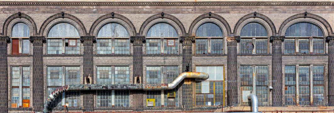 Facade of an abandoned old industrial building background