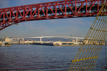 Obraz premium Sailing Through Osaka Bay with Bridges