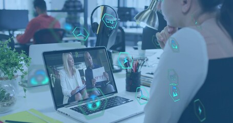 Watching woman in sleeveless top viewing hosts on laptop at office, with hex overlays, copy space