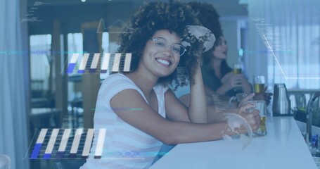 Smiling adult woman with curly hair leaning at bar counter, holding beer glass with HUD overlay