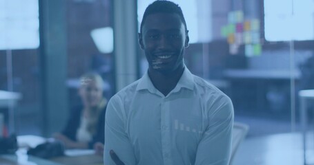 Obraz premium Standing man wearing white shirt, crossing arms, smiling in office with sticky notes on glass