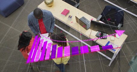 Analyzing three colleagues in orange jacket, yellow top discussing magenta AR chart at office desk