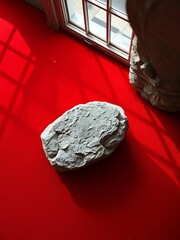 Perfectly cut stone rests on a crimson canvas of untold stories,  ethical sourcing,  rarity