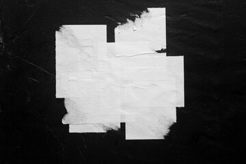 Close-up of a torn street poster on a black background