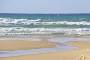 beautiful sandy beach and waves on the Mediterranean Sea in Israel.