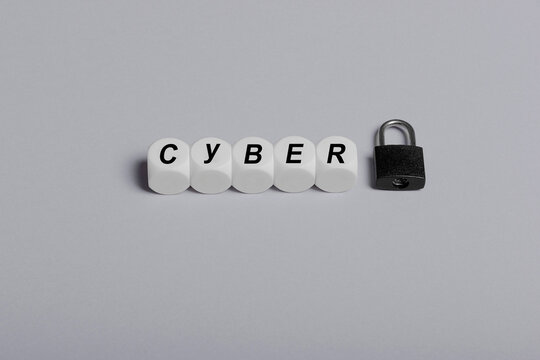 Cyber letter cubes with black padlock on gray background.