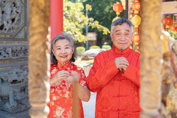 portrait asian senior couple praying a wish at incense burner together in chinese shrine,concept of...