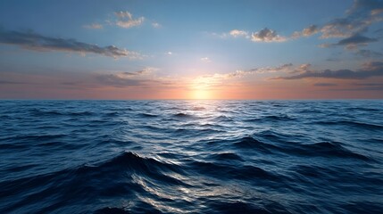 A vast deep blue ocean surface with gentle waves set against a dramatic sunset sky filled with warm orange pink and golden light