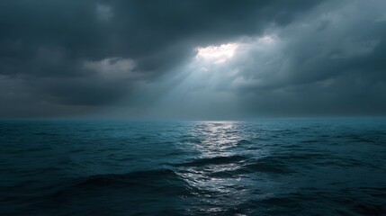 Dramatic ocean seascape with light breaking through stormy clouds