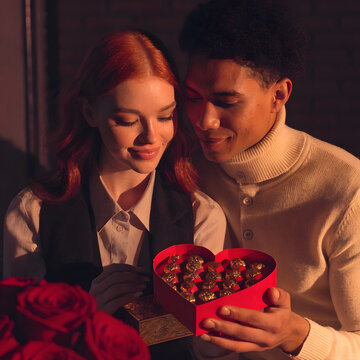 couple sharing valentines gifts with warm lightin