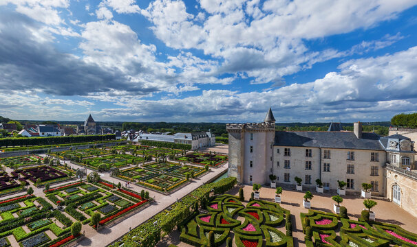 Aerial view of the Chateau de Chaumont-sur-Loire gardens in full bloom, a tapestry of colour and manicured hedges under a vast, dramatic sky, Chaumont-sur-Loire, Centre-Val de Loire, France.