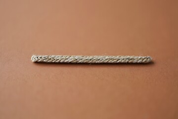 A simple white rope on a brown background