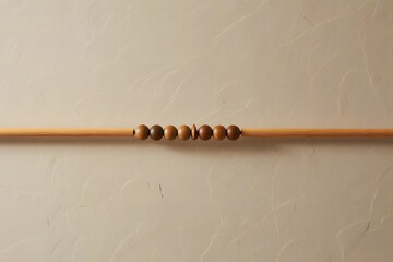 Wooden dowel with beads on a textured wall