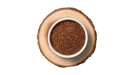 A white bowl filled with nutritious finger millet seeds resting on a rustic wooden slice