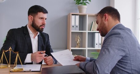 Professional serious male lawyer consulting client, giving recommendation, going to sign contract, helping with legal documentation, giving general law guidance. Law services concept 