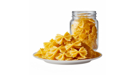 A vibrant display of uncooked bow tie pasta presented on a white plate with a full glass jar in the background