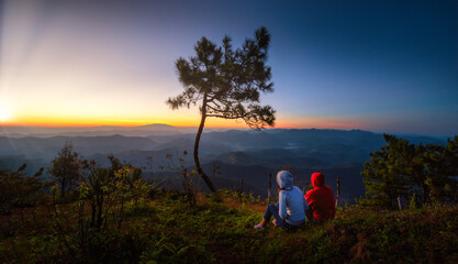 Traveller looking sunrise scene with the peak of mountain and Mist at Phu chi phe in Mae Hong Son Province,Thailand
