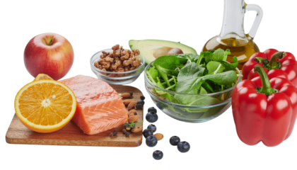 Assortment of food including an apple orange fish nuts salad oil and red pepper on a wooden board object on white and png