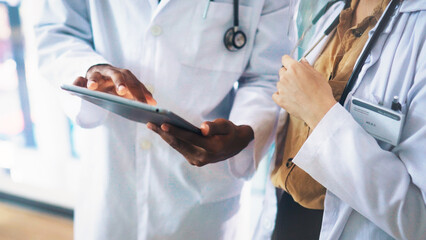 Collaboration, hands and tablet with doctors in hospital together for medical consulting. App,...