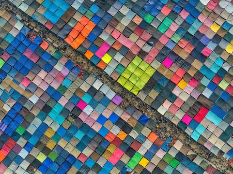 Aerial view of a vibrant tapestry of tents, their colorful fabrics creating a mosaic of shelter and community, Tongi, Dhaka Division, Bangladesh.