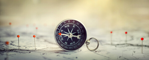 Compass  and location marking with a pin on routes on world map. Adventure, discovery, navigation,...