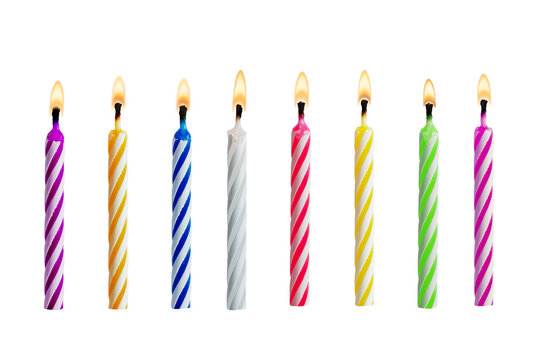 Set of colorful birthday candles with flames isolated on transparent background. Multicolored candles for design birthday themes.