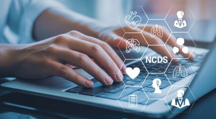 NCDS and technology in health research: a professional uses a laptop at work while working on technology solutions for healthcare.