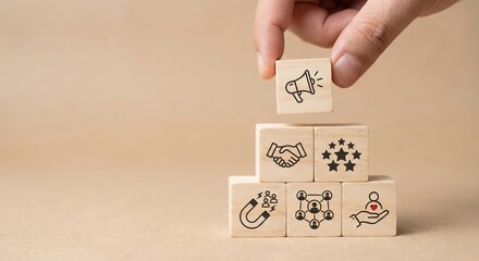 Close up of an adult hand placing a wooden block with a customer loyalty icon on a stack, marketing strategy and community building concept, clean indoor studio, business growth and retention.