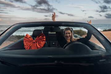 Happy Woman Receiving a Car as a Gift