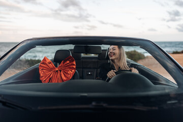 Happy Woman Receiving a Car as a Gift