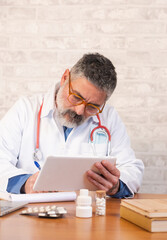 Doctor using digital tablet for medical consultation and prescription