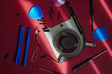 Computer Cooling Fan and Tools on Red.