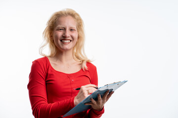 Photo of gorgeous blond secretary woman with blonde hair writing down notes in clipboard while working in office