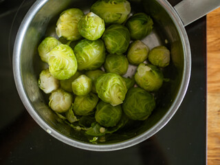Cooked Brussels sprouts in pot on electric stove