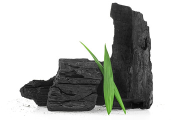 Natural wooden charcoal with powder and green leaves isolated on a white background. Concept cosmetic. Activated carbon.