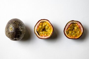 Whole and Halved Passion Fruit on White Background