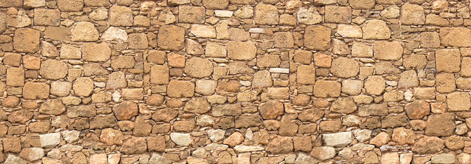 Ancient rough hewn stone wall texture pattern