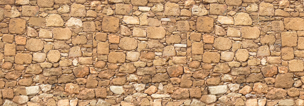 Ancient rough hewn stone wall texture pattern
