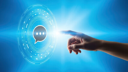 Human hand touching glowing chat icon in futuristic digital interface creating concept of communication technology