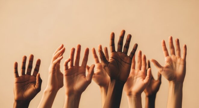 Multiple Diverse Human Hands Raised High Against a Warm Neutral Background Symbolizing Unity