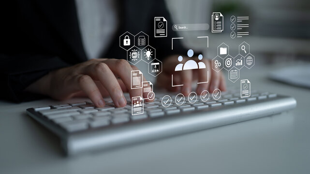 Business professional working on a computer keyboard with digital icons representing data security, teamwork, and project management in a modern office setting Gantry.