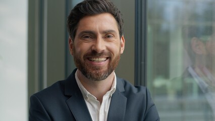 Fototapeta premium Portrait happy smiling toothy Caucasian middle-aged business man looking at camera smile in office adult 40s businessman male manager employer entrepreneur satisfied positive good job work success