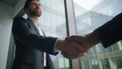 Caucasian business man leader boss talking with African American client in office shaking hands teamwork welcoming greeting conclude deal. Two diversity multiracial businessmen colleagues handshaking