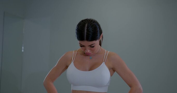 Young woman practicing neck flexion and extension in a studio during a wellness session