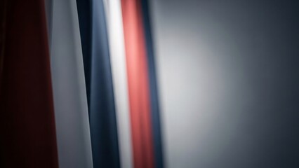 Abstract blurred red, white, and blue vertical stripes on gray background