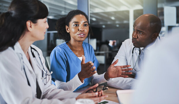 Discussion, doctor and team in meeting for healthcare report, brainstorming or feedback for nurse. Group, medical professionals and people planning with support for collaboration in hospital clinic - Powered by Adobe