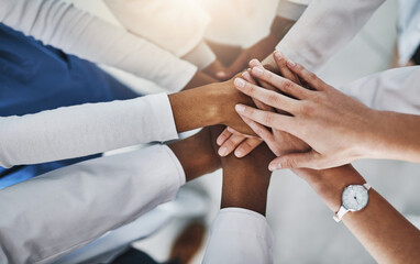 Obraz premium Stack of hands, support and team of doctors in hospital with unity, healthcare or collaboration. People, top view and group of medical employees with celebration for treatment success in clinic.